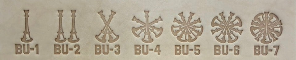 Group of seven delrin leather stamps showing firefighter bugle rank insignia.