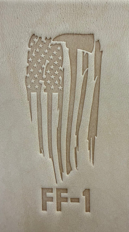 Delrin leather stamp pressing a tattered U.S. flag design with a firefighting axe and Halligan bar into leather.