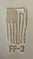 Delrin leather stamp pressing a tattered U.S. flag design with a firefighting axe and Halligan bar into leather.