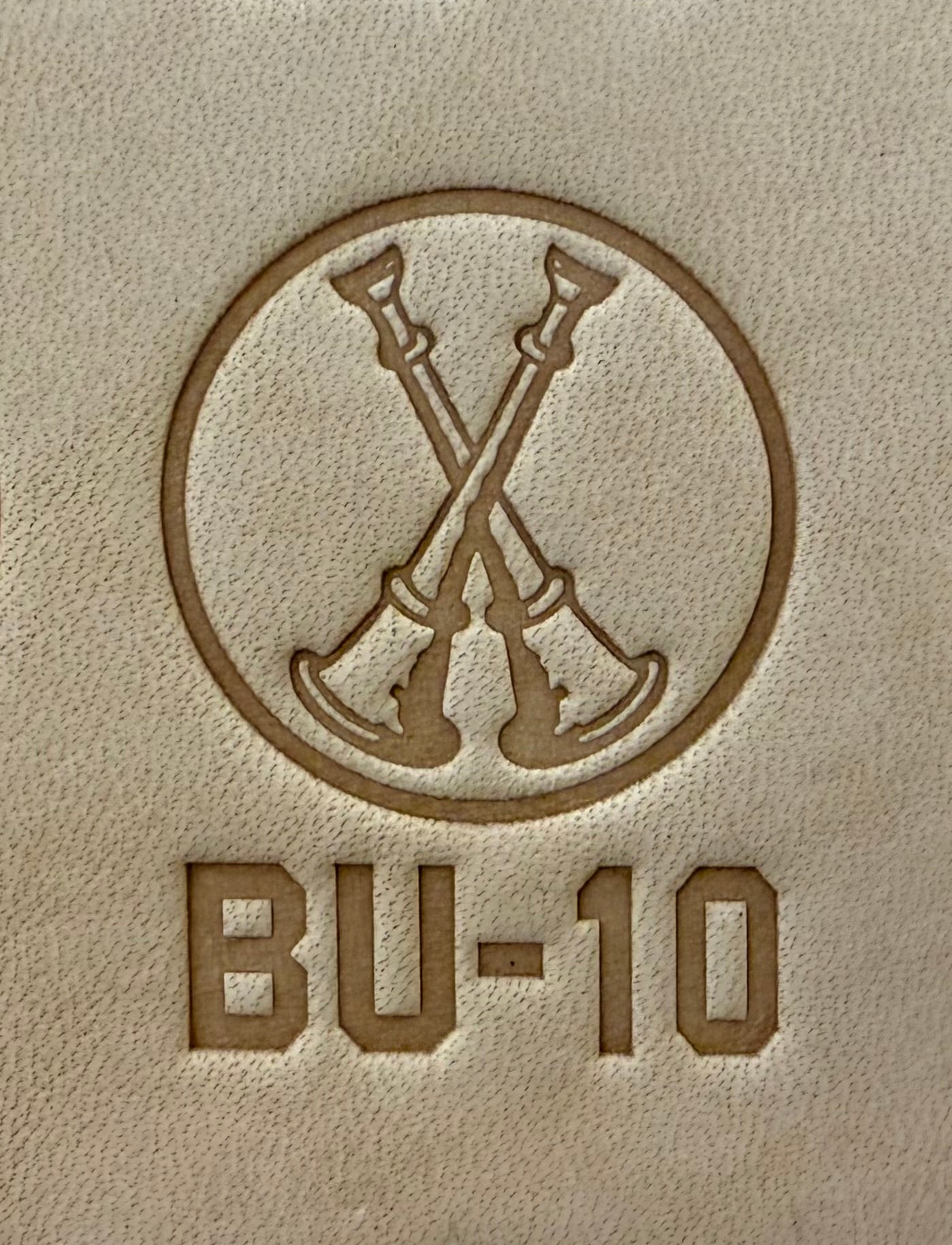 Delrin leather stamp showing firefighter bugle rank insignia.