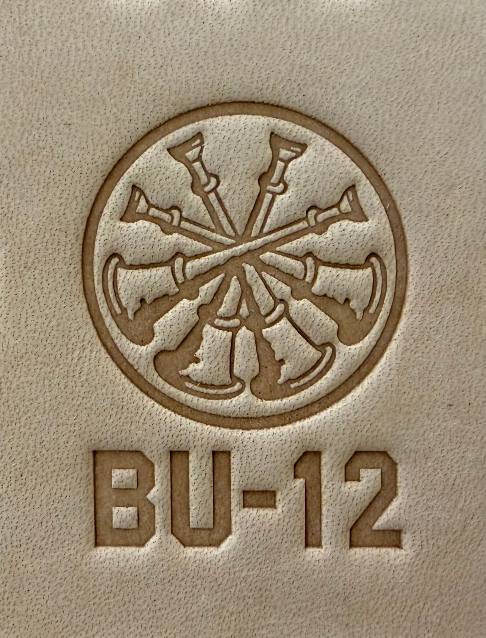 Delrin leather stamp showing firefighter bugle rank insignia.