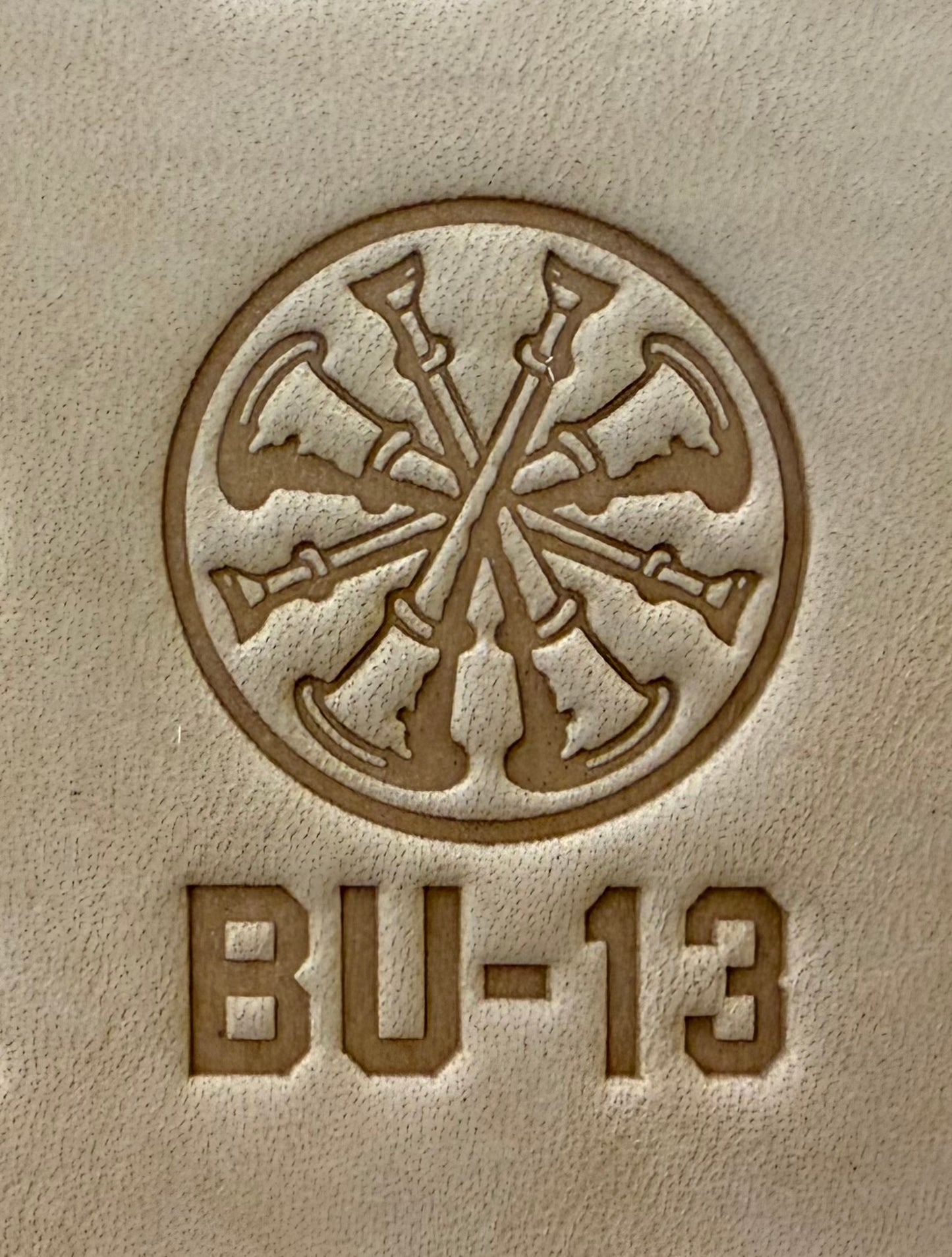 Delrin leather stamp showing firefighter bugle rank insignia.
