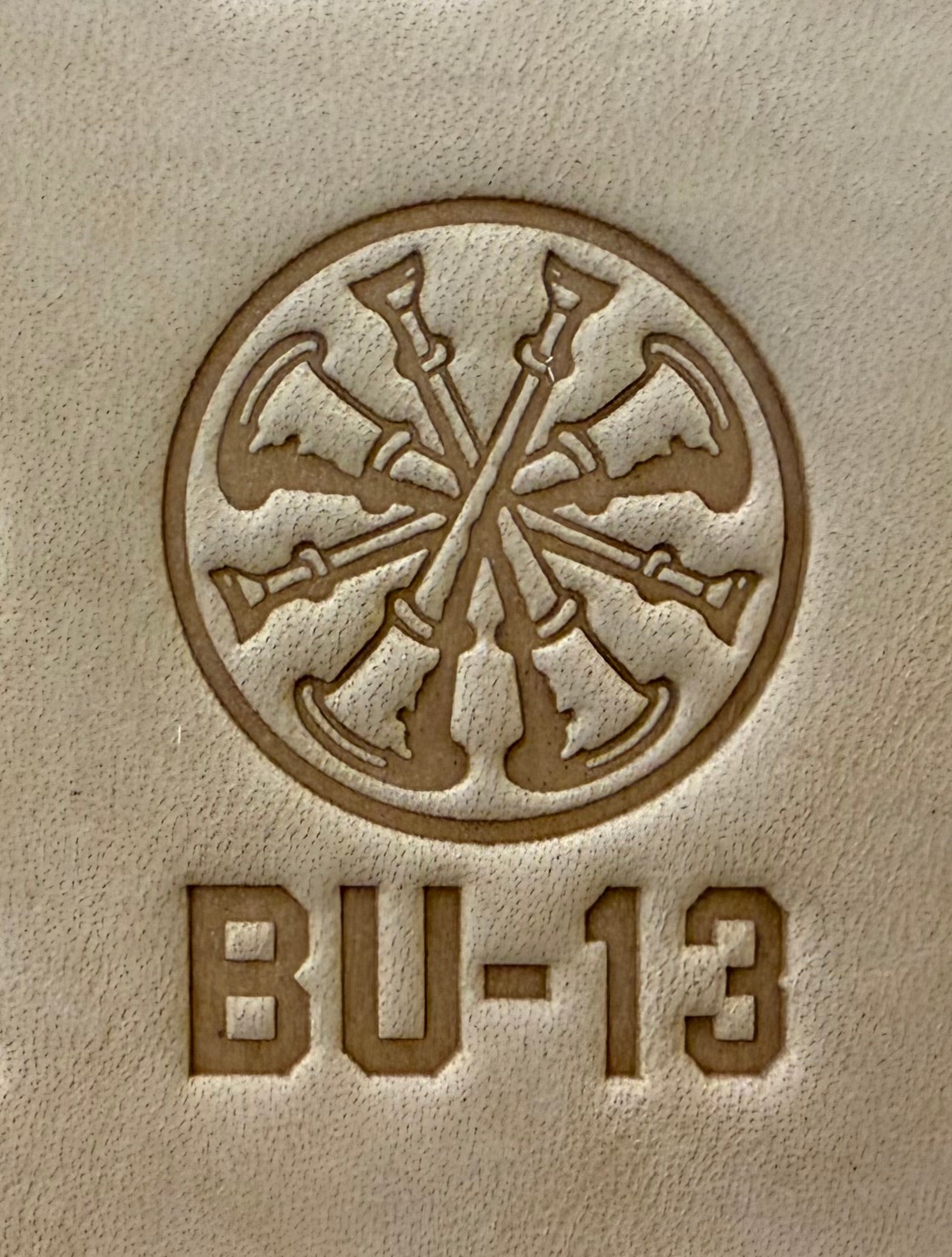 Delrin leather stamp showing firefighter bugle rank insignia.