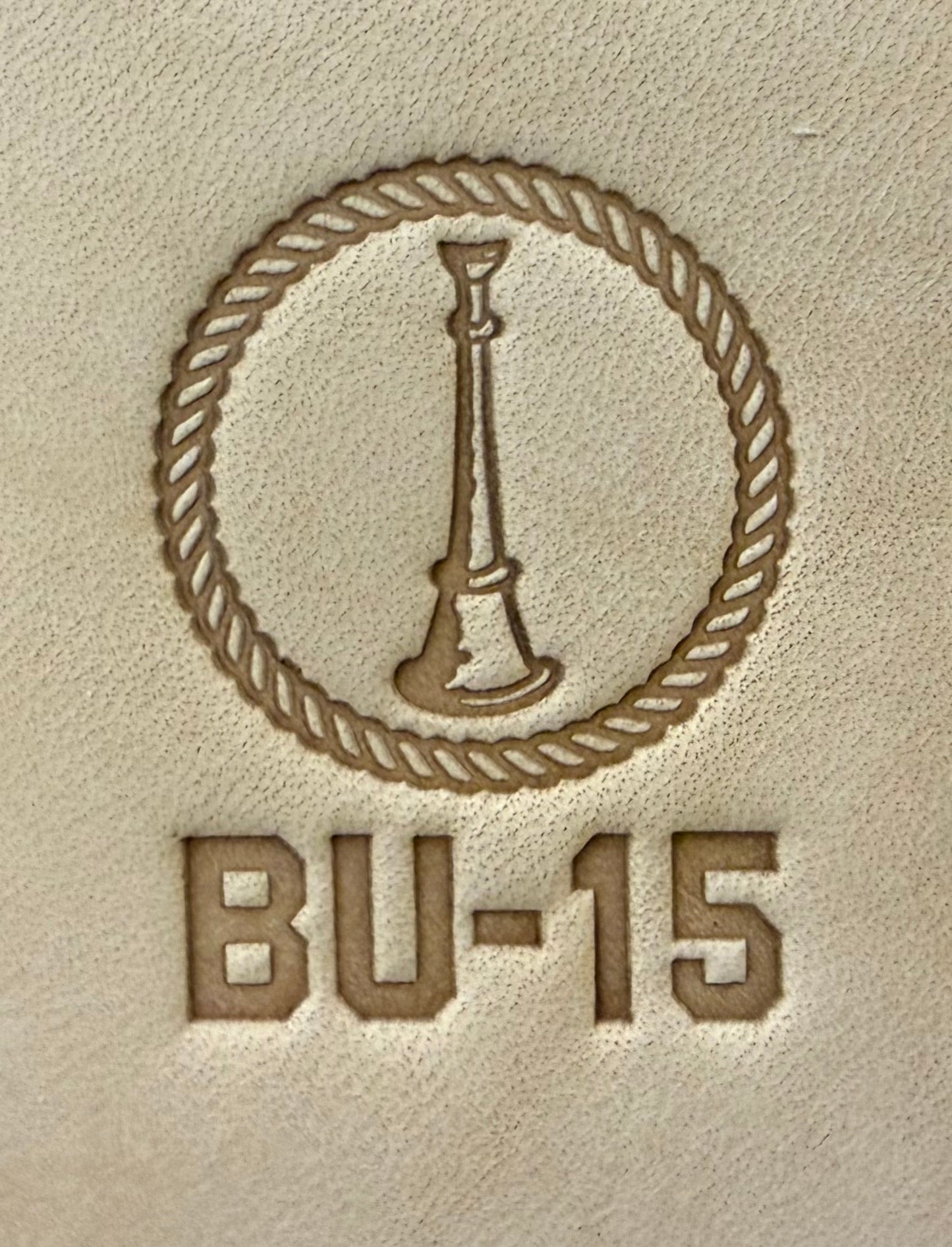 Delrin leather stamp showing firefighter bugle rank insignia.