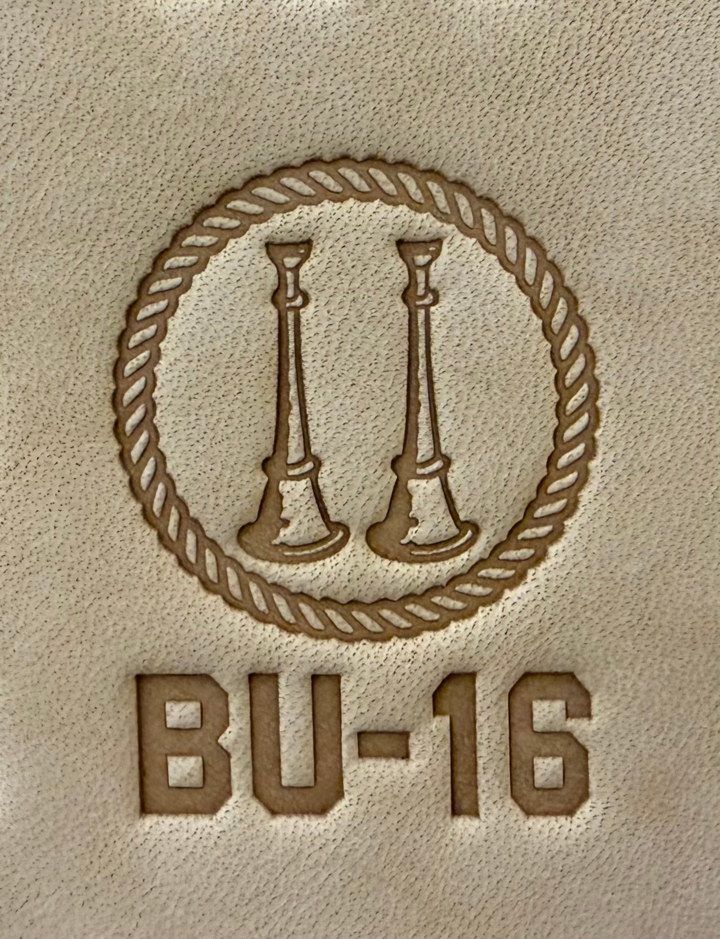 Delrin leather stamp showing firefighter bugle rank insignia.