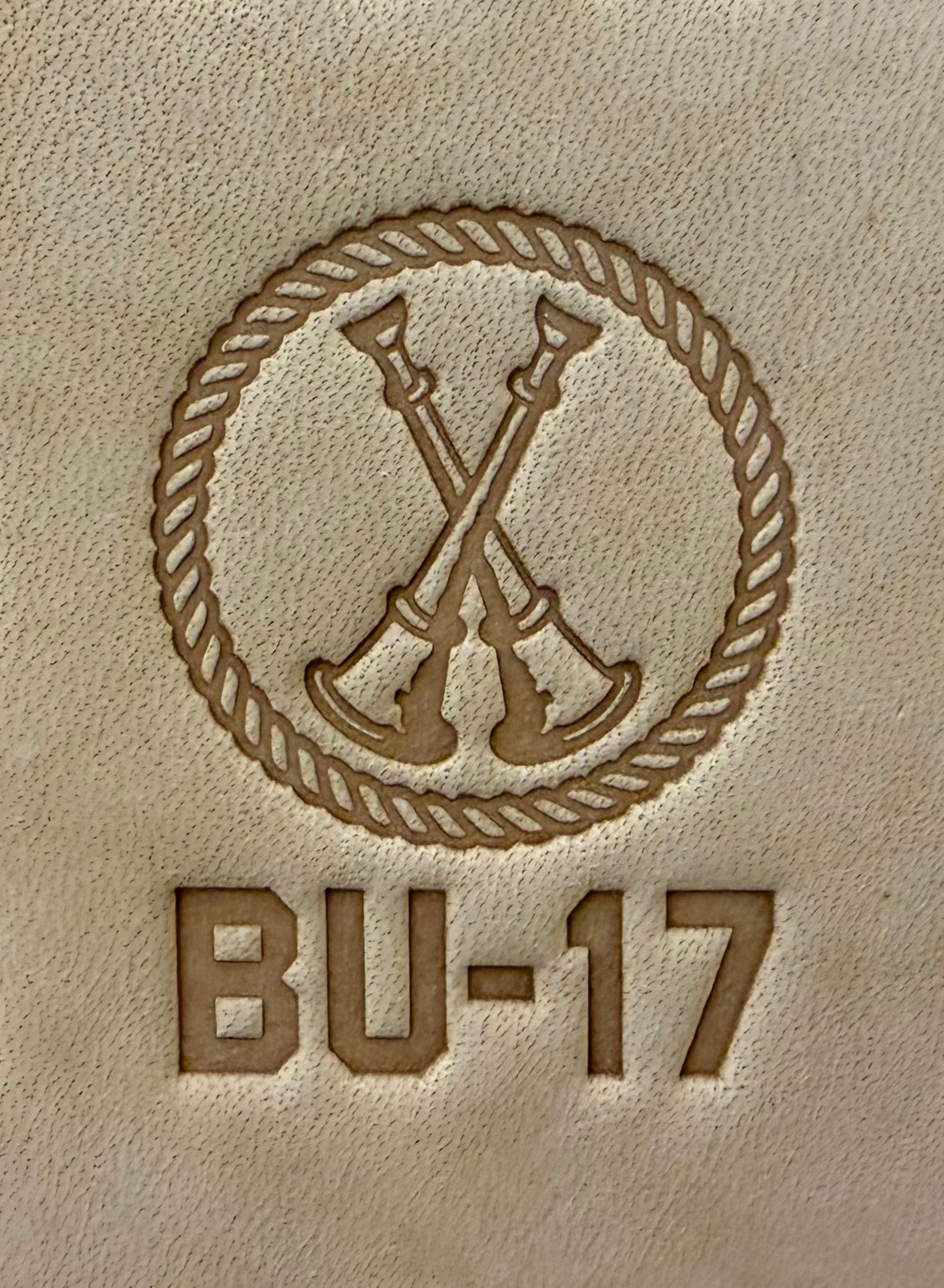 Delrin leather stamp showing firefighter bugle rank insignia.
