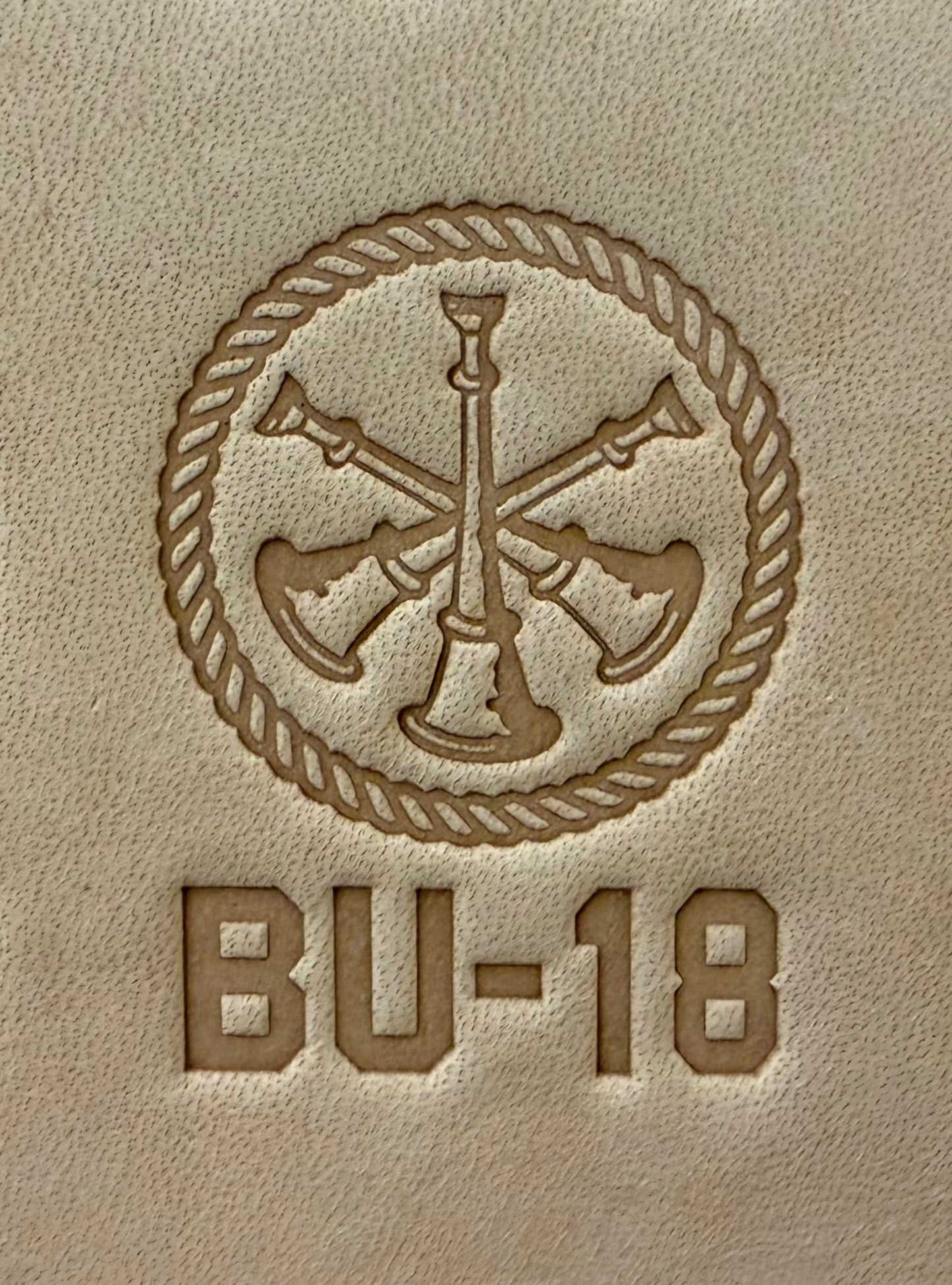 Delrin leather stamp showing firefighter bugle rank insignia.