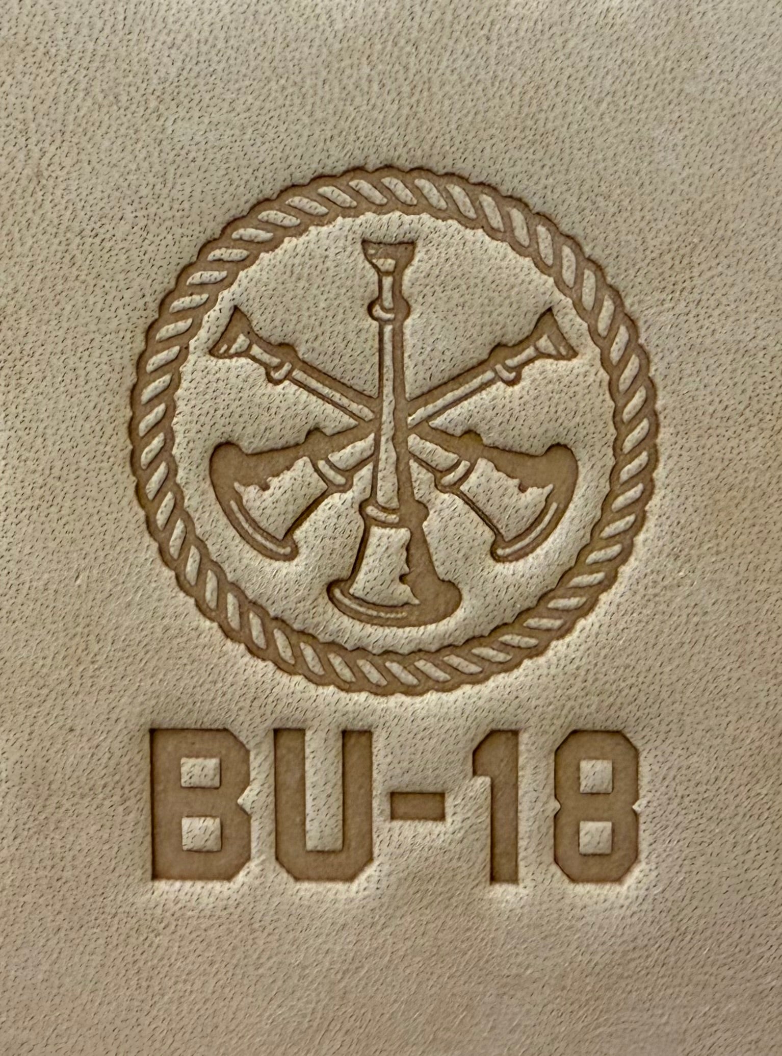 Delrin leather stamp showing firefighter bugle rank insignia.