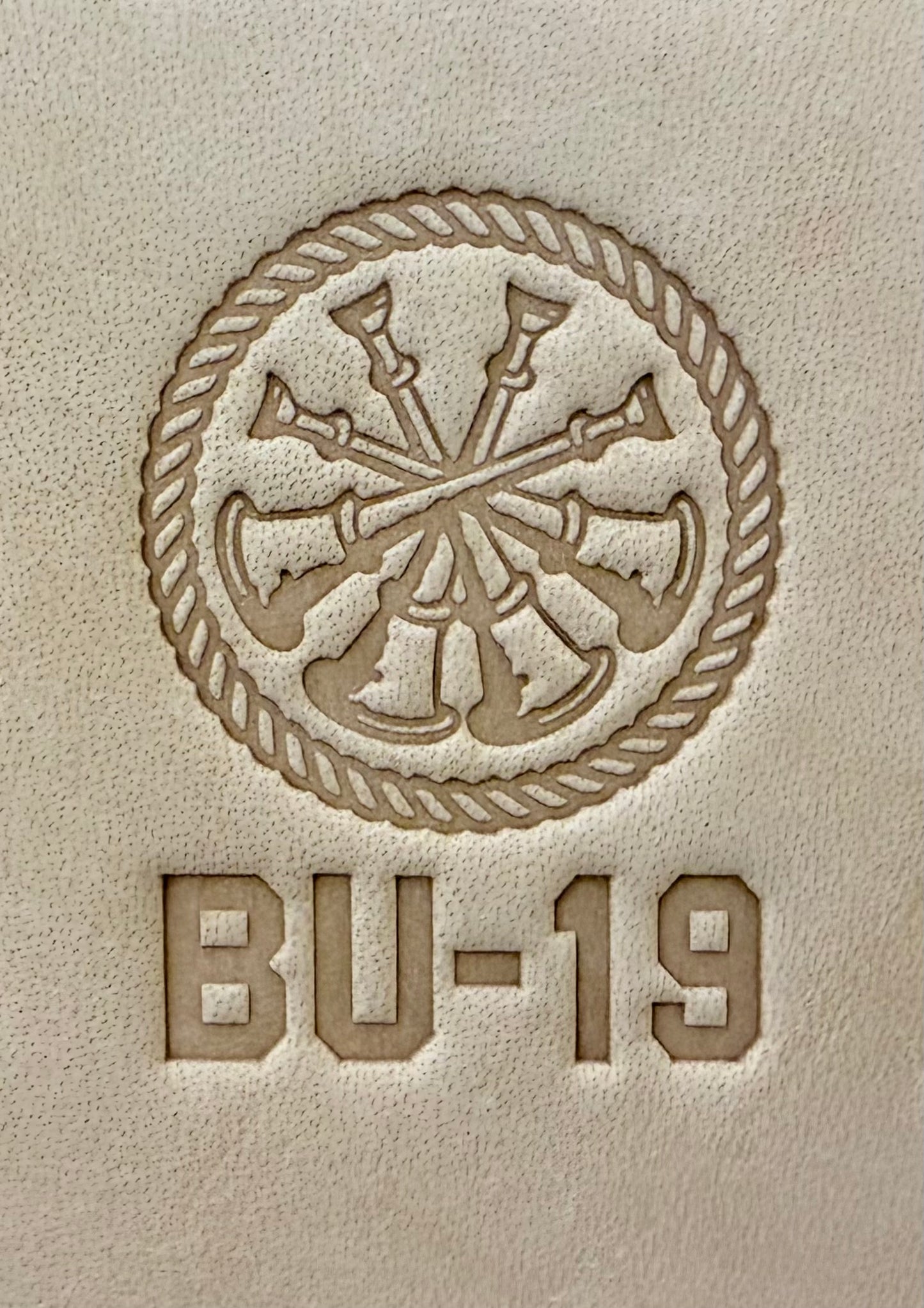 Delrin leather stamp showing firefighter bugle rank insignia.