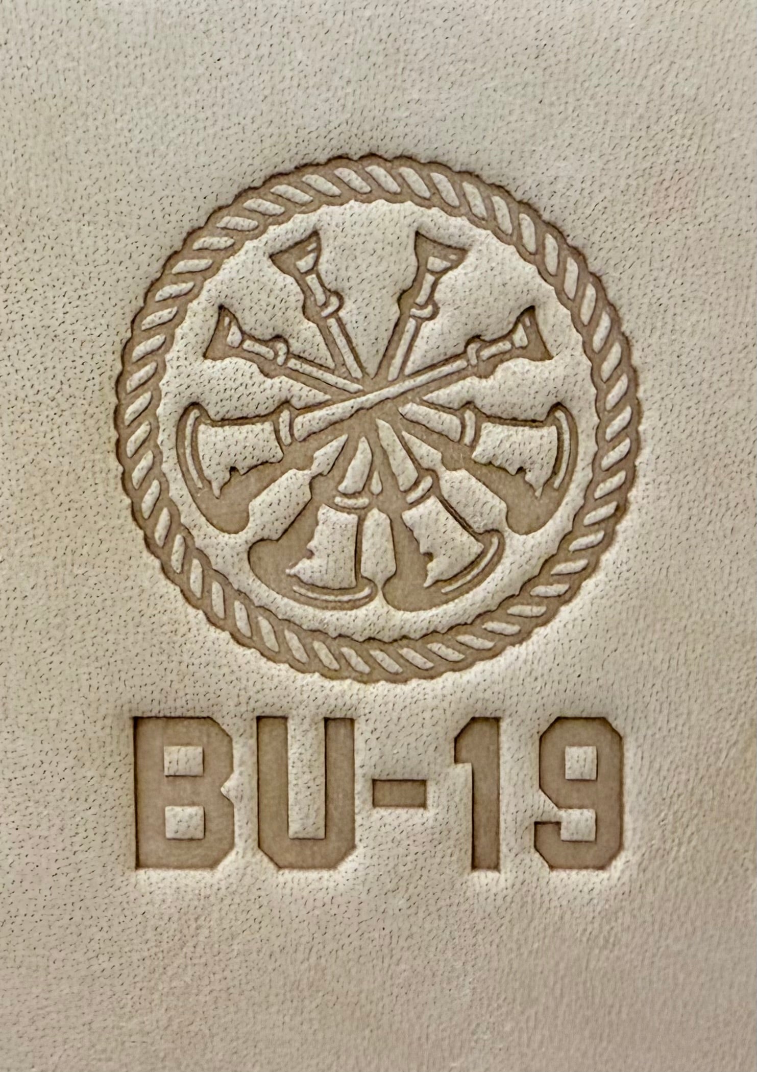 Delrin leather stamp showing firefighter bugle rank insignia.