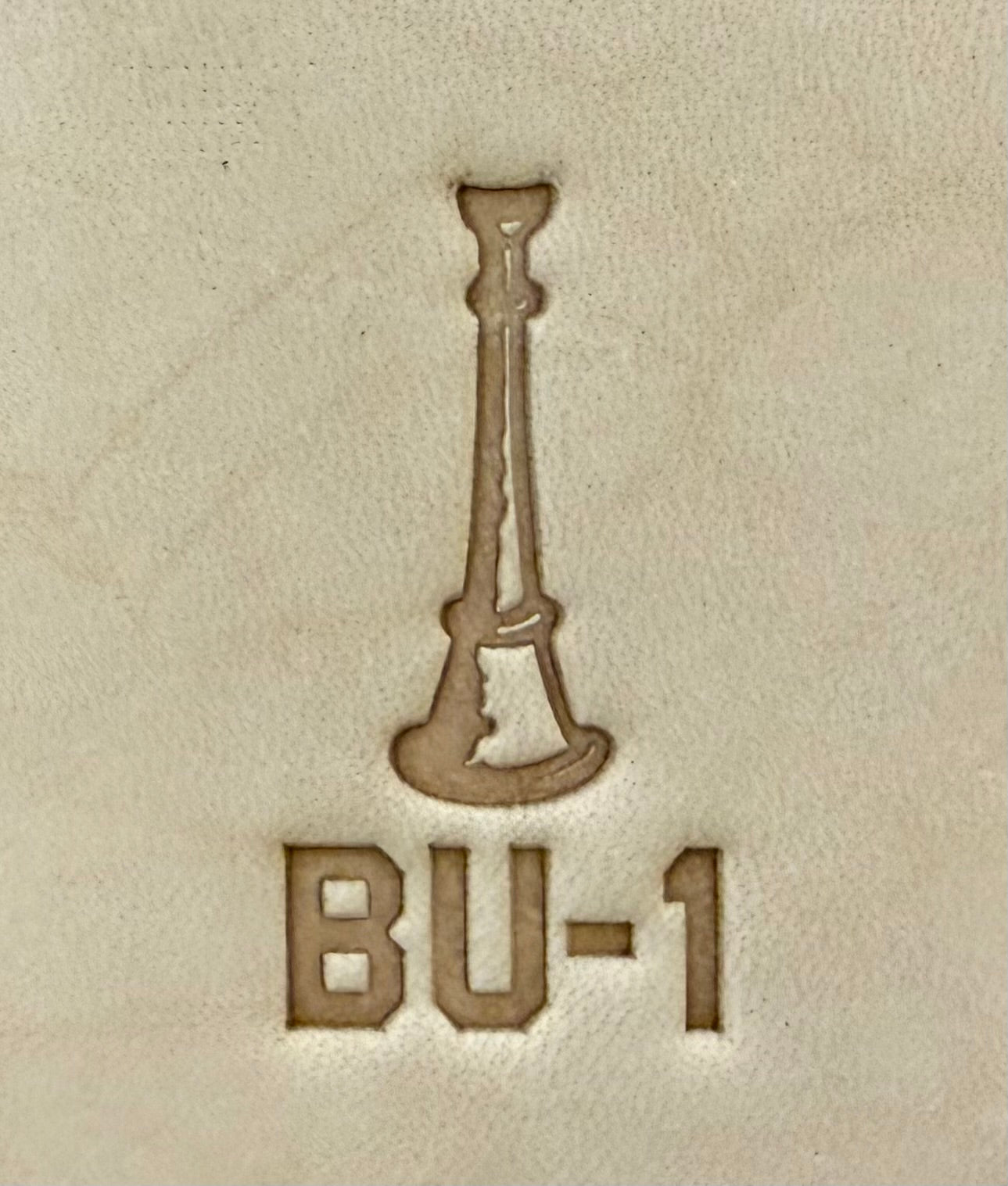 Delrin leather stamp showing firefighter bugle rank insignia.