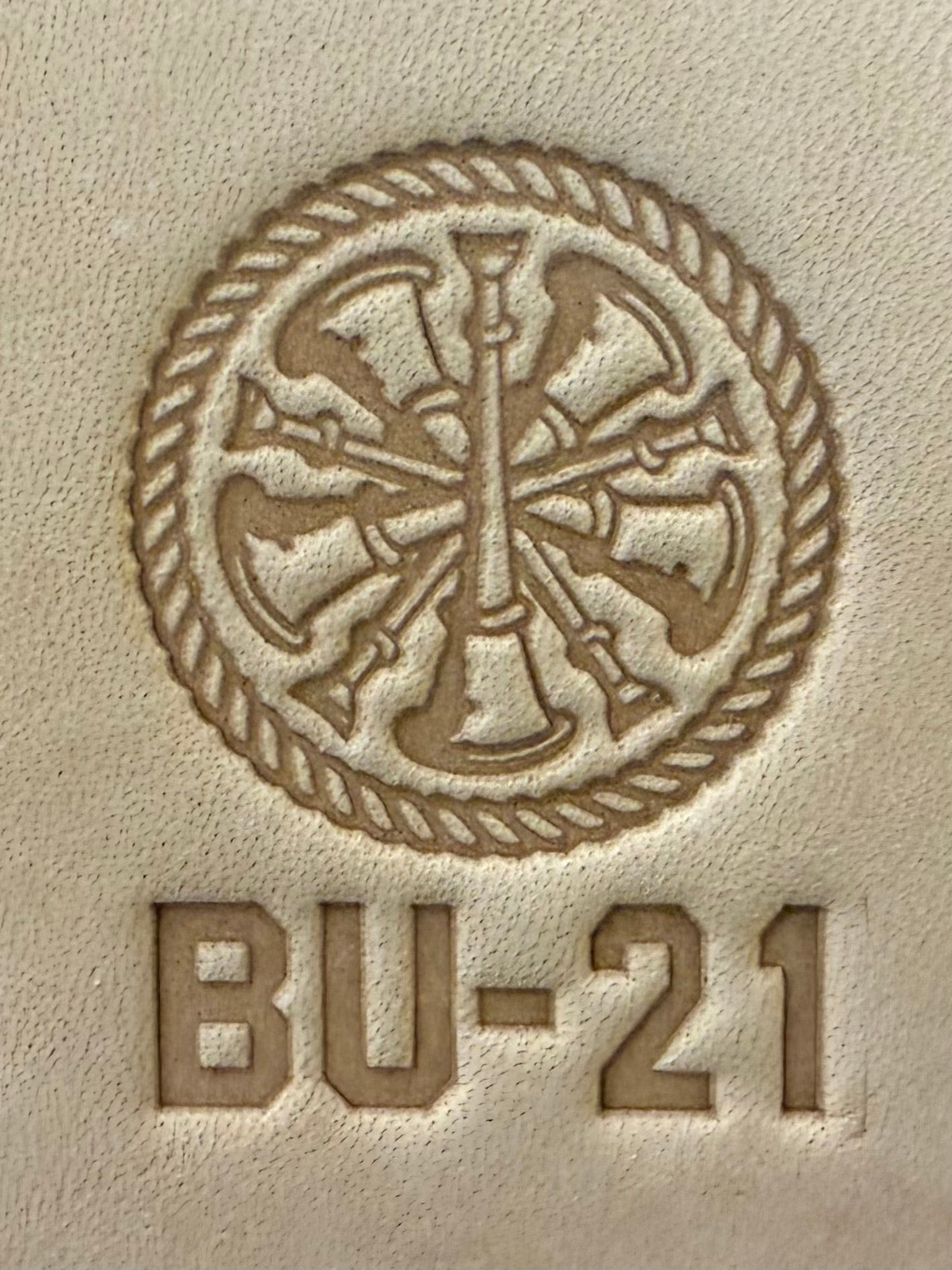 Delrin leather stamp showing firefighter bugle rank insignia.