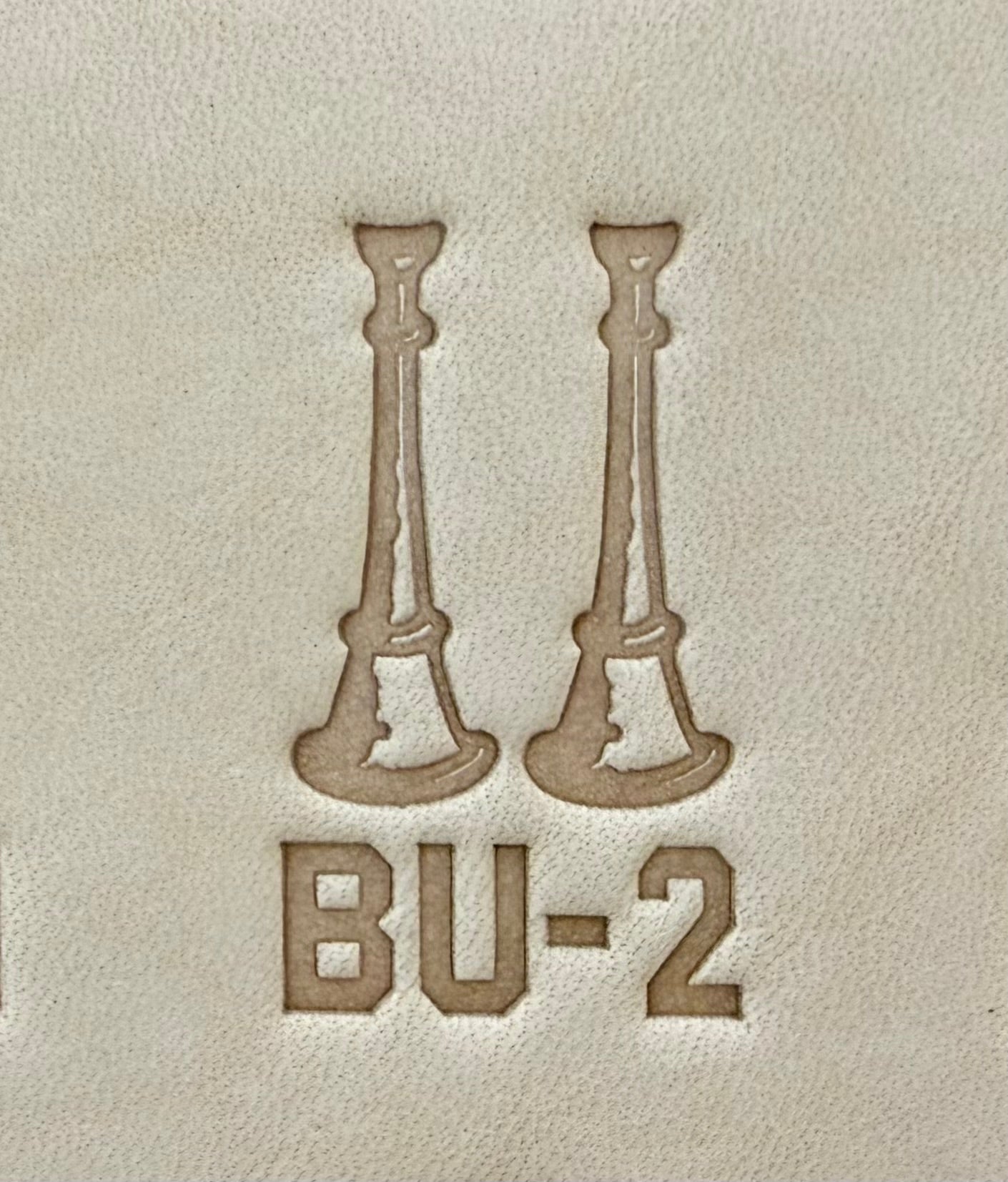 Delrin leather stamp showing firefighter bugle rank insignia.