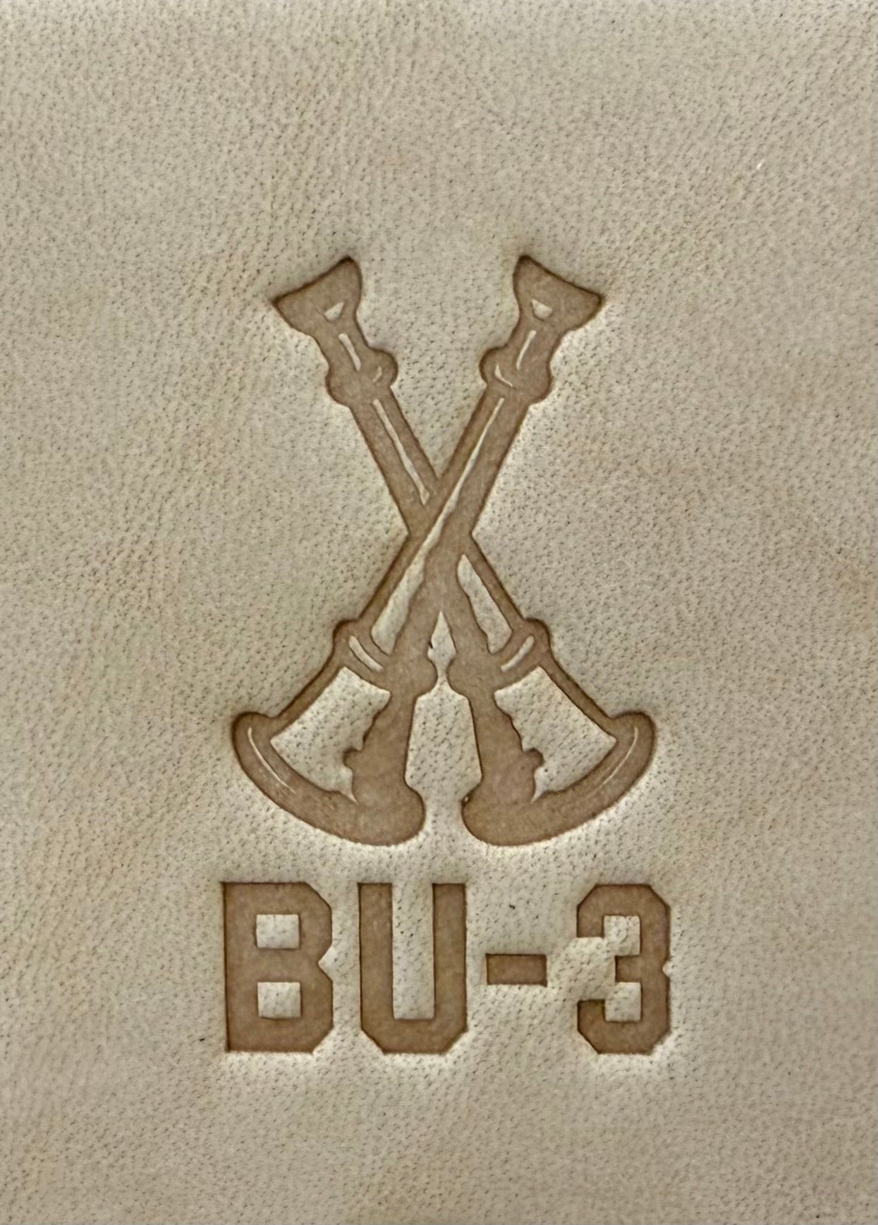 Delrin leather stamp showing firefighter bugle rank insignia.