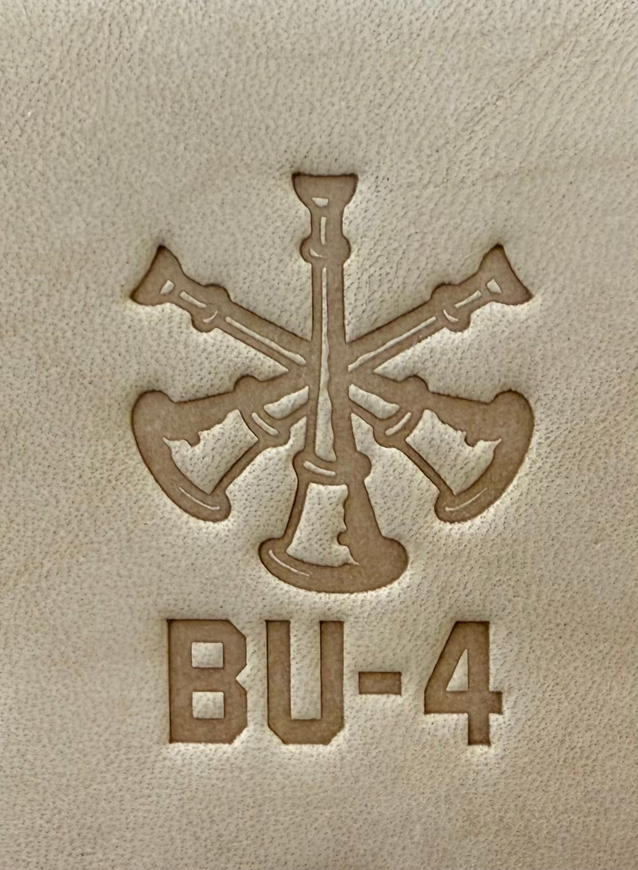 Delrin leather stamp showing firefighter bugle rank insignia.