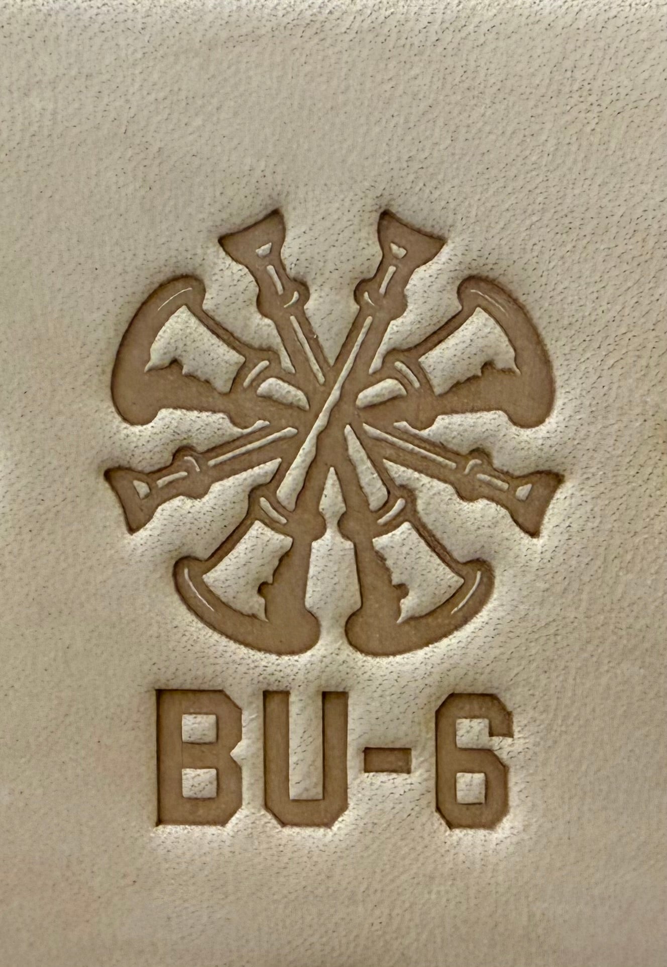 Delrin leather stamp showing firefighter bugle rank insignia.