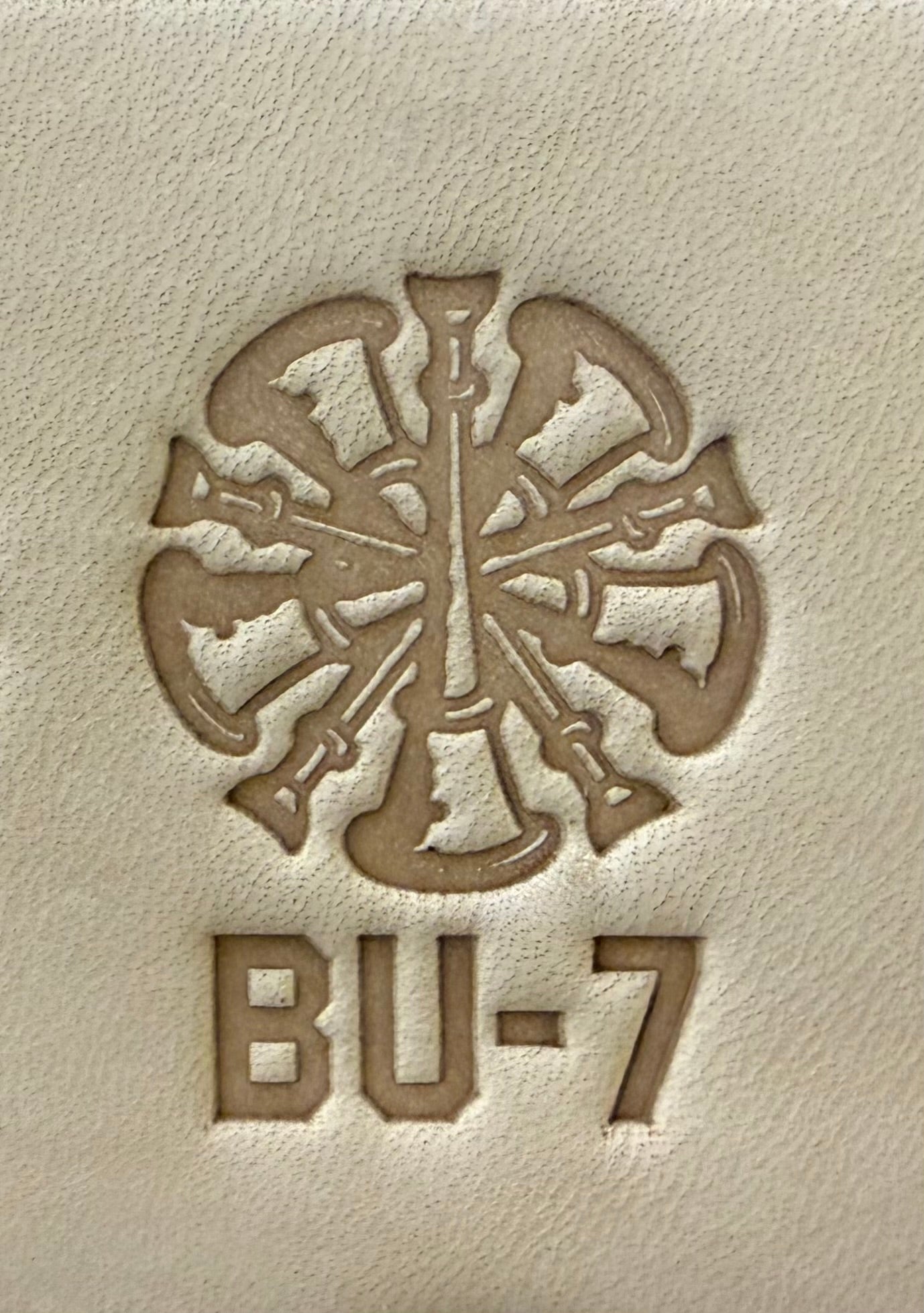Delrin leather stamp showing firefighter bugle rank insignia.