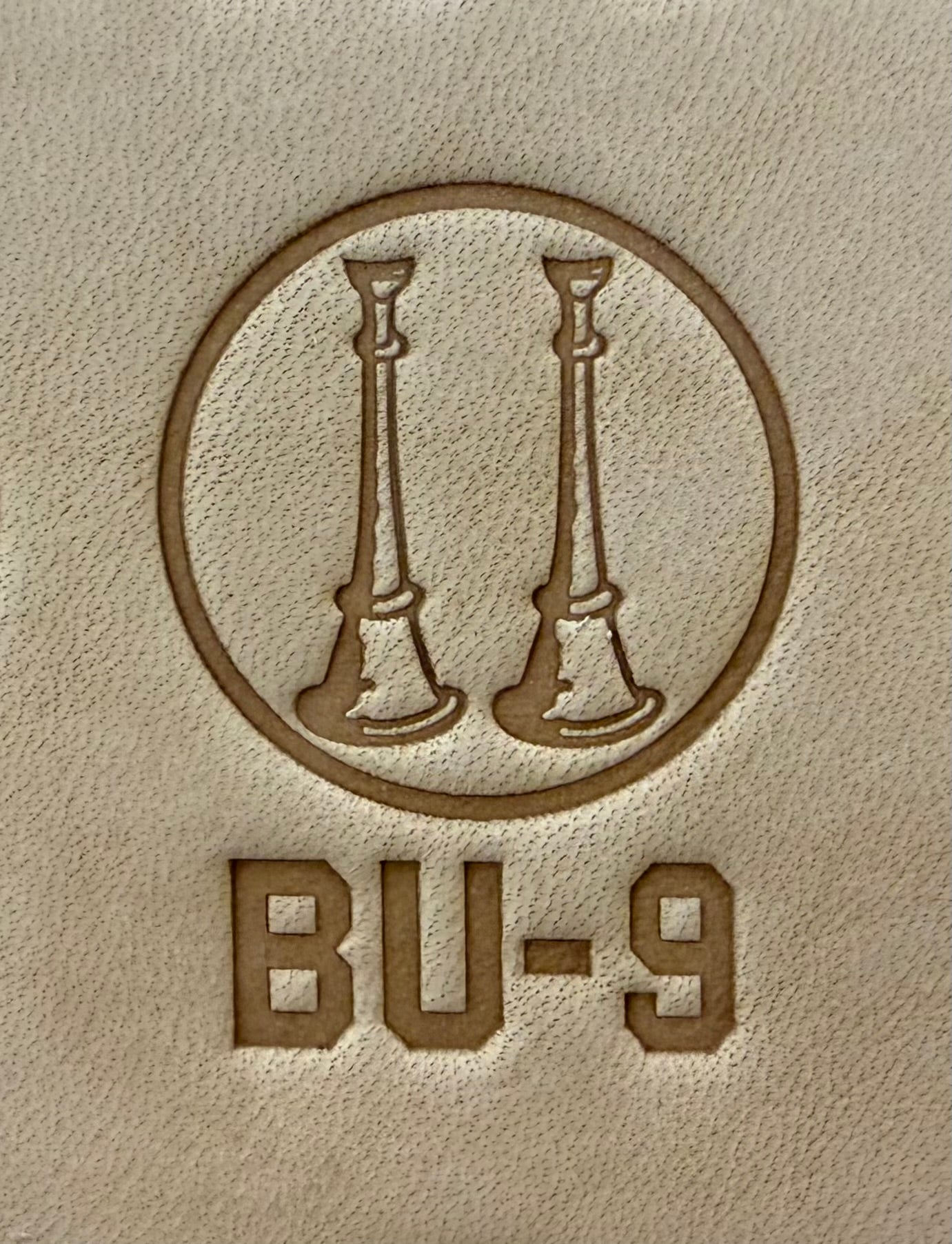 Delrin leather stamp showing firefighter bugle rank insignia.