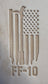 Delrin leather stamp pressing a tattered U.S. flag design with a firefighting axe and Halligan bar into leather.