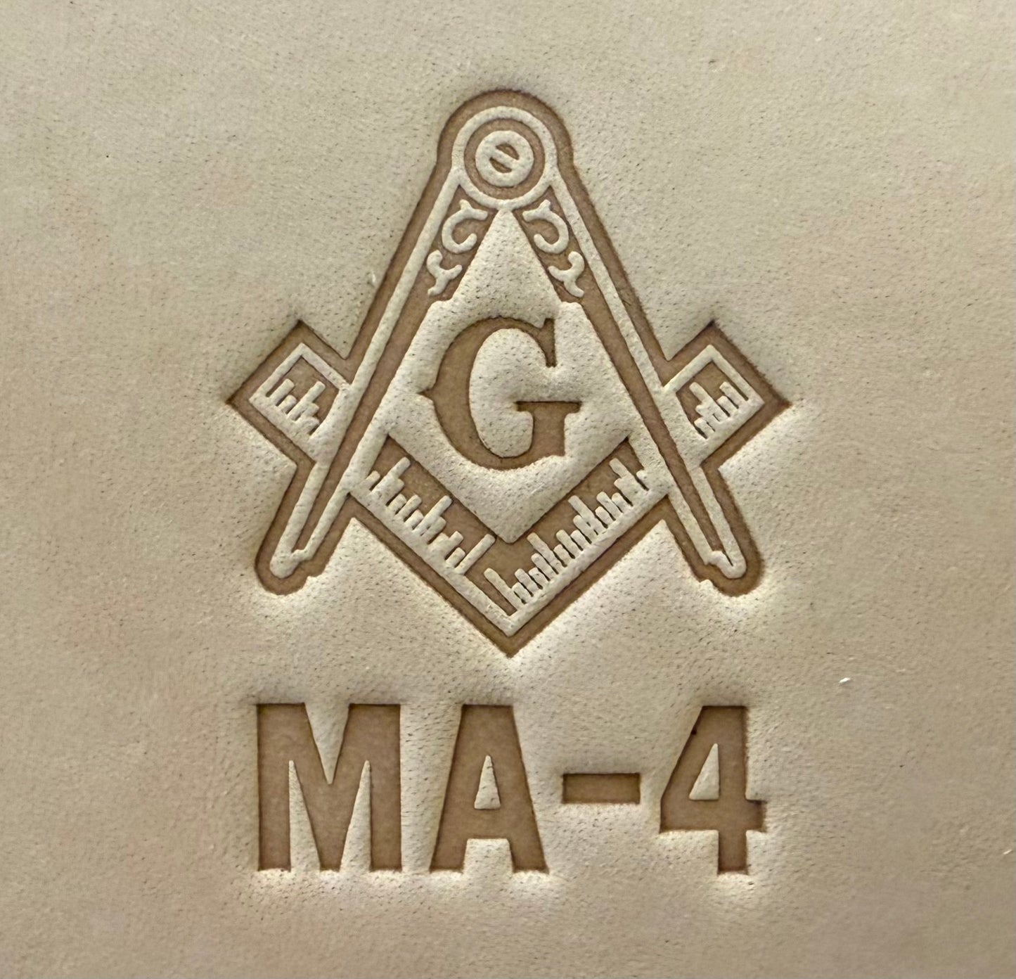 Embossing stamp featuring a Masonic square and compass emblem with the letter G.