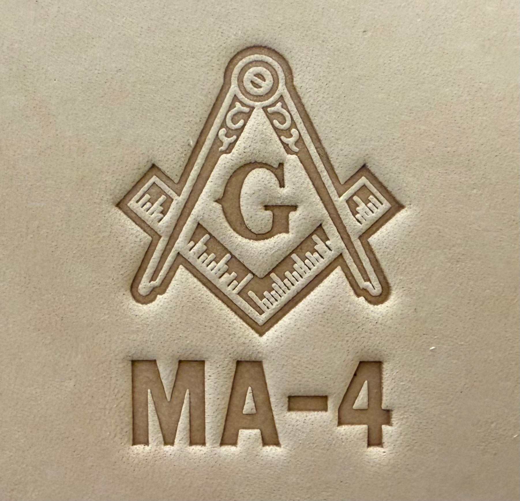 Embossing stamp featuring a Masonic square and compass emblem with the letter G.