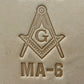 Embossing stamp featuring a Masonic square and compass emblem with the letter G.