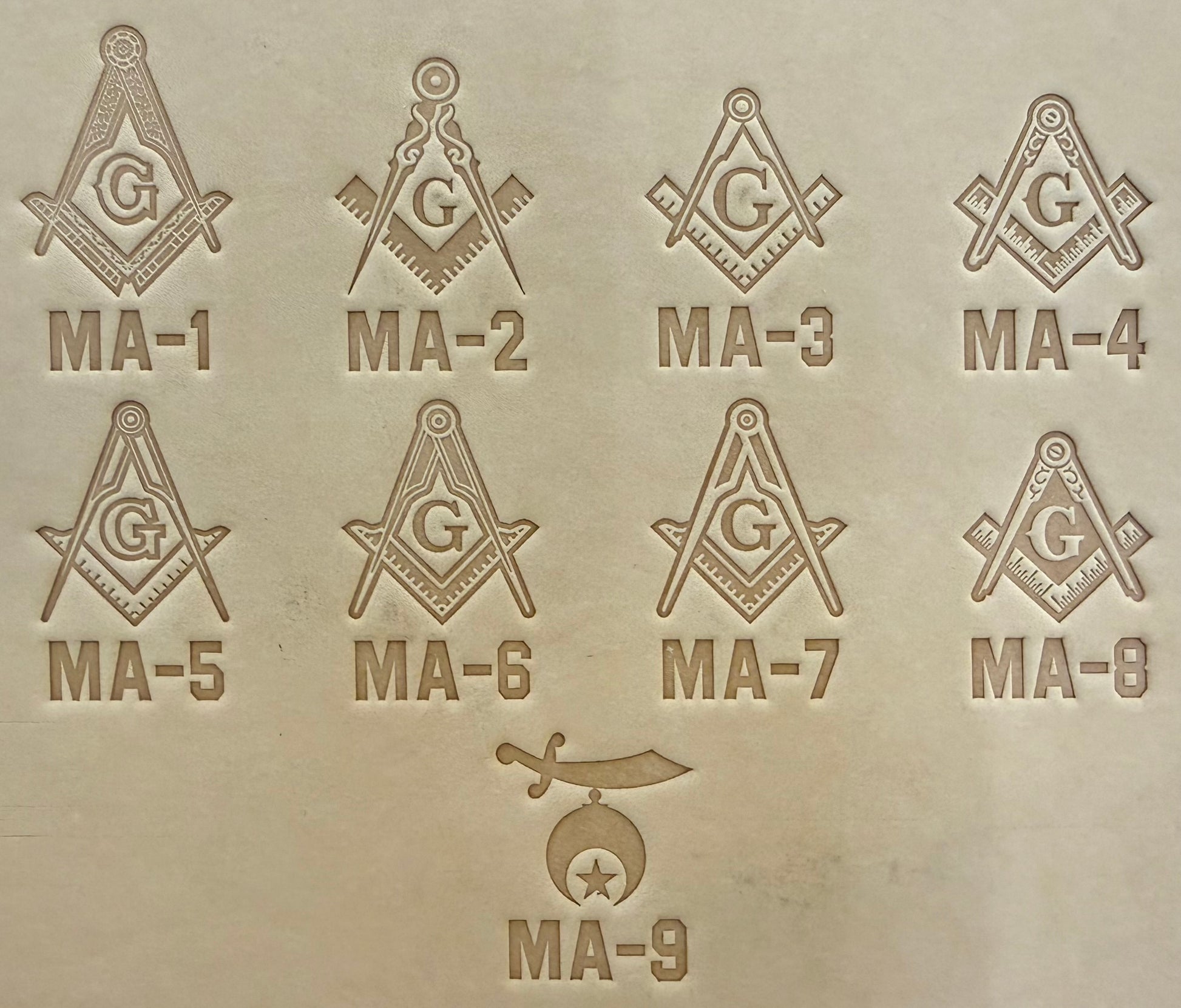 Embossing stamp featuring a Masonic square and compass emblem with the letter G and Shrine Emblem Crescent and Star.