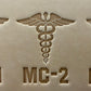 Leathercrafting impression of a medical caduceus symbol.