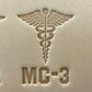 Leathercrafting impression of a medical caduceus symbol.