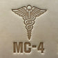 Leathercrafting impression of a medical caduceus symbol.