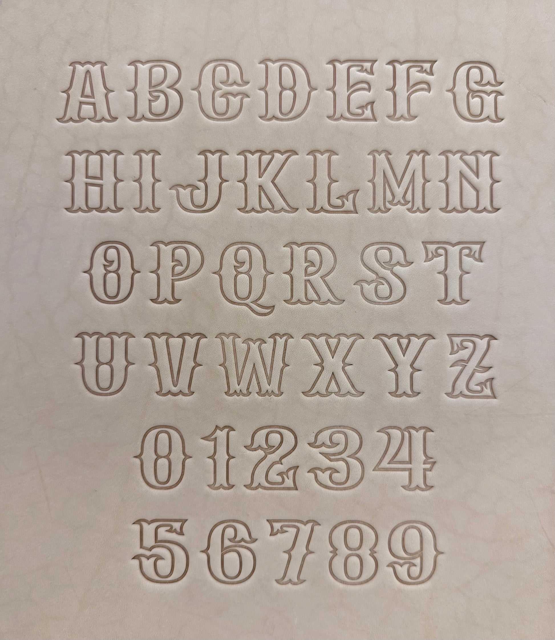 Leathercrafting embossing stamp in western style font.
